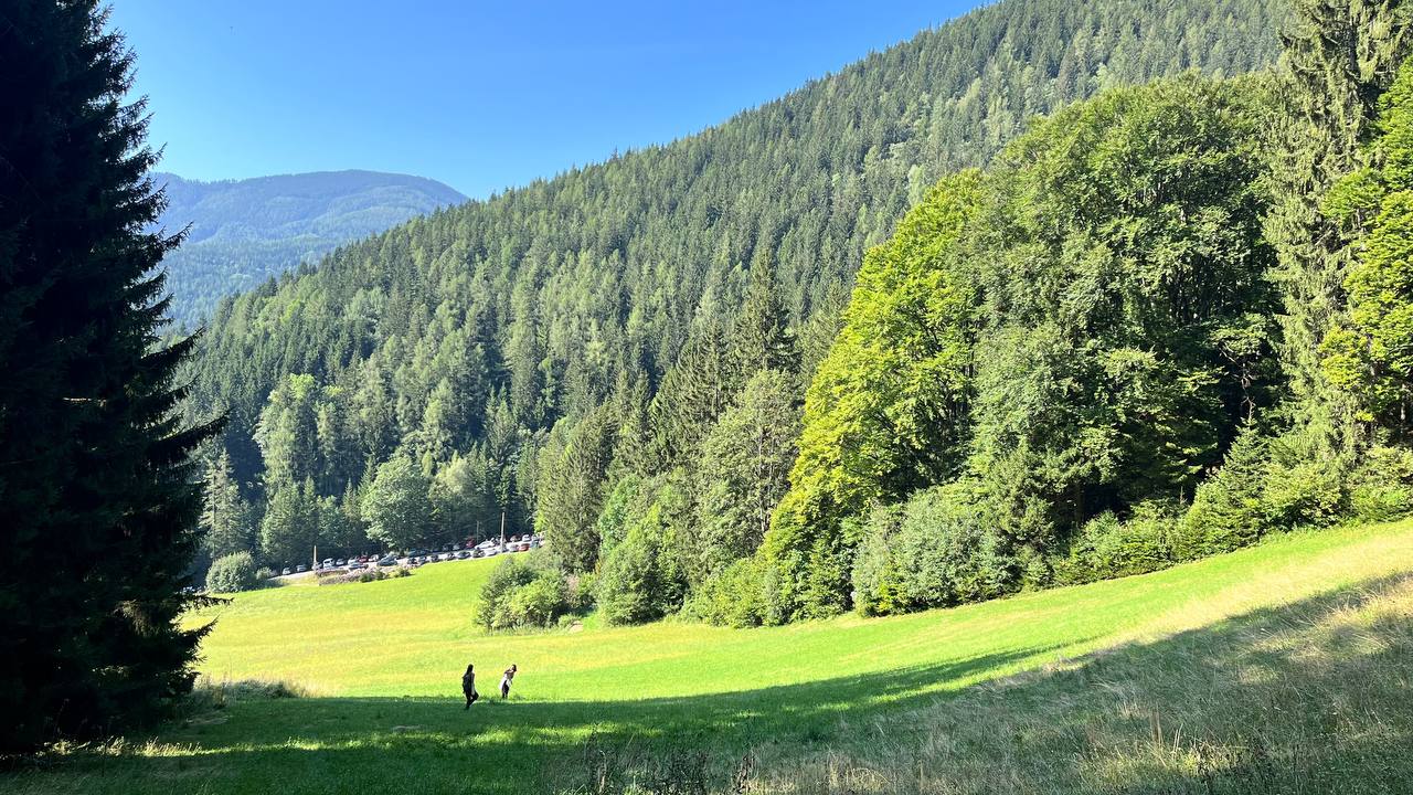 People walking in a green valley